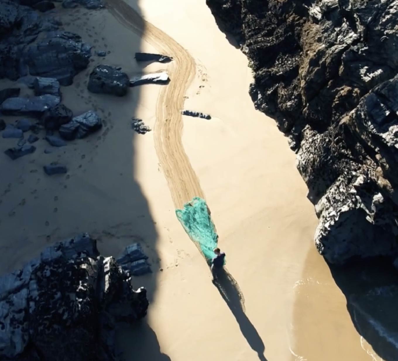 Man dragging fishing net from sea