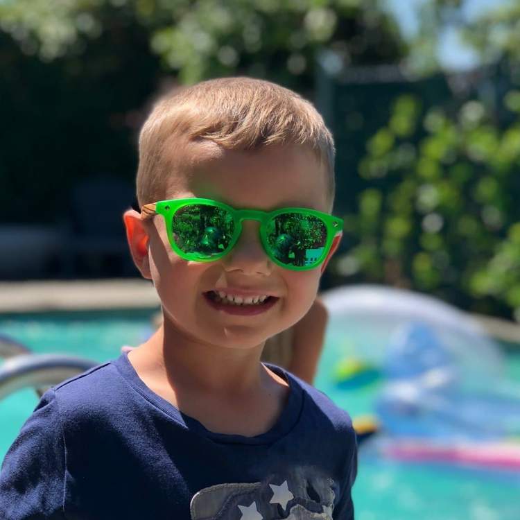 Boy in green cat eye sunglasses