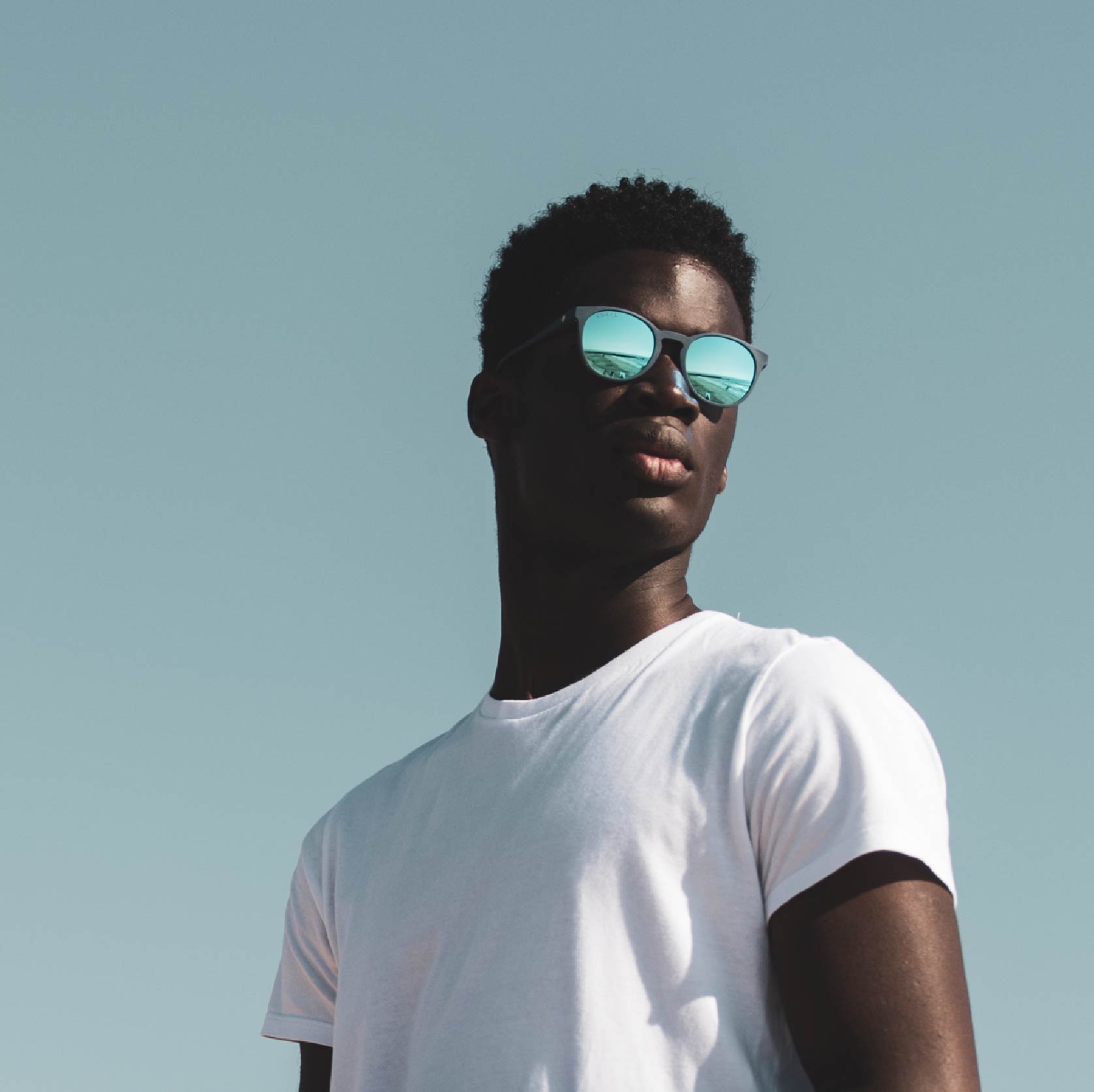 Man with sunglasses and blue sky