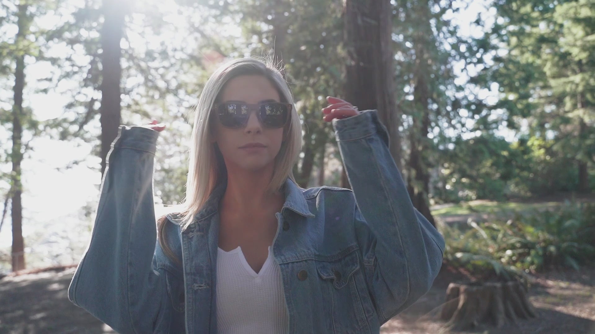 Woman in a forest wearing Wildwood sunglasses